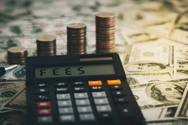 Calculator with the word FEES on the calculator placed on the dollar, concepts, fees, fees services and taxes.
