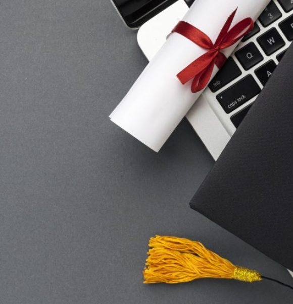 top-view-laptop-with-diploma-academic-cap
